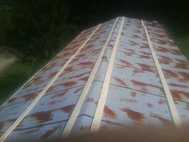 Rusted metal roof panels with new wood purlins before replacement — Storm Damage Roof Repair in Caneyville by Roofing Brothers